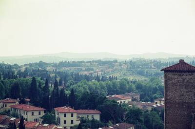 Hilly green outskirts and rooftops below a tower — Florence, Italy (26-27 May 2000)