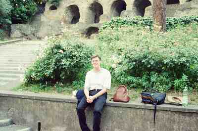 Richard seated on a wall before rose bushes in the Forum — Rome, Italy (21-27 May 2000)