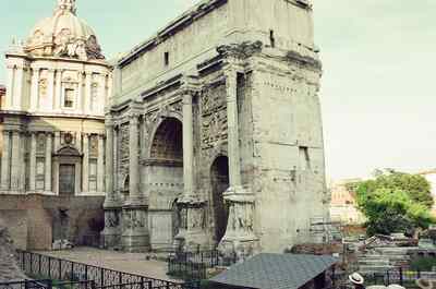 The Arch of Septimius Severus beside a baroque church — Rome, Italy (21-27 May 2000)