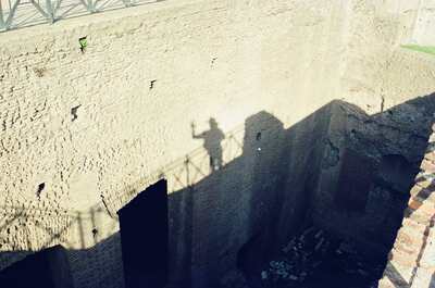 A photographer's shadow cast on sunlit Palatine brick walls — Rome, Italy (21-27 May 2000)