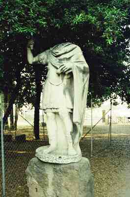 A headless draped Vestal statue among forum greenery — Rome, Italy (21-27 May 2000)