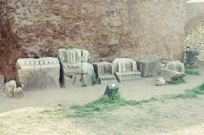 Carved architectural fragments lined against a stone wall — Rome, Italy (21-27 May 2000)