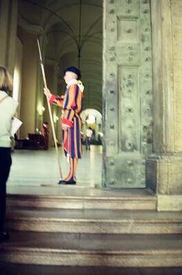 A Swiss Guard standing watch by the bronze doors — St Peter's Basilica, Vatican City (21-27 May 2000)