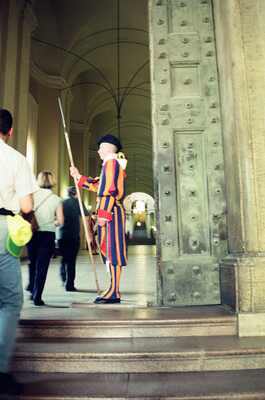 A Swiss Guard with halberd beside the basilica doors — St Peter's Basilica, Vatican City (21-27 May 2000)