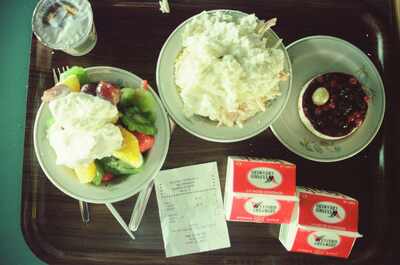 A tray of fruit salad, dessert and milk cartons — Ireland, Ireland (4-9 July 2000)