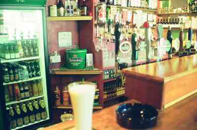 Bottle fridge and beer taps behind a pub bar — Ireland, Ireland (4-9 July 2000)