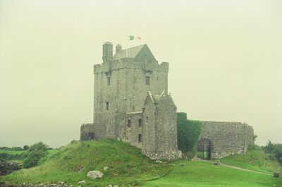 Dunguaire Castle tower house flying the Irish flag — Kinvara, Ireland (4-9 July 2000)