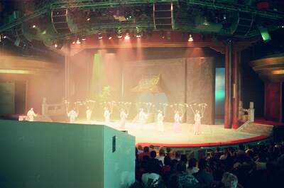 Performers with parasols on a brightly lit theatre stage — Disneyland Paris, France (2-8 July 2000)