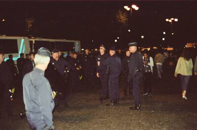 Police vans and officers gathered in a night square — Paris, France (2-8 July 2000)