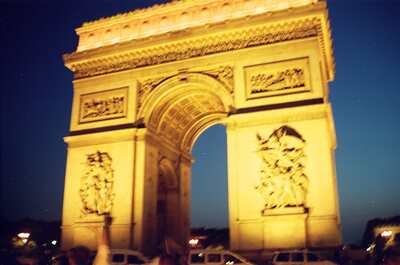 The illuminated Arc de Triomphe at twilight — Paris, France (2-8 July 2000)