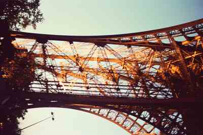 The Eiffel Tower ironwork glowing at sunset — Paris, France (2-8 July 2000)