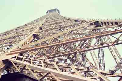 The Eiffel Tower soaring overhead against pale sky — Paris, France (2-8 July 2000)