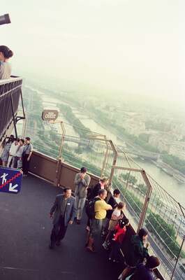 Visitors on the Eiffel Tower observation deck above Paris — Paris, France (2-8 July 2000)