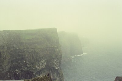 Sheer Cliffs of Moher receding along a misty coast — County Clare, Ireland (29 June - 6 July 2000)