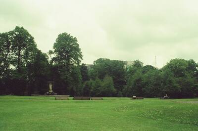 Empty benches on a green lawn in a city park — Dublin, Ireland (29 June - 6 July 2000)