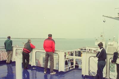 Passengers at the rail watching the sea from a ferry deck — In transit, in transit (29 June - 6 July 2000)