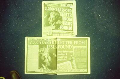 A sensational tabloid newspaper spread on a ferry carpet — In transit, in transit (29 June - 6 July 2000)
