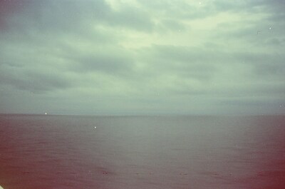 Calm grey sea under a moody overcast sky from the ferry — In transit, in transit (29 June - 6 July 2000)