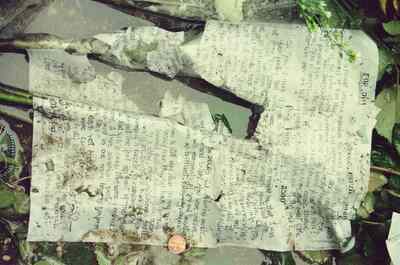 Weathered handwritten notes left at Jim Morrison's grave — Paris, France (29 June - 6 July 2000)