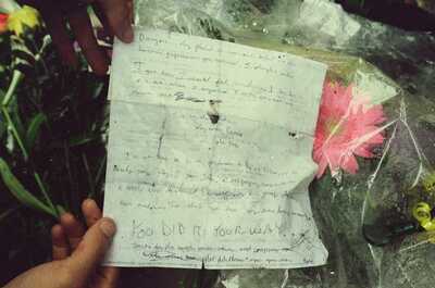 A hand holding a heartfelt letter at Jim Morrison's grave — Paris, France (29 June - 6 July 2000)