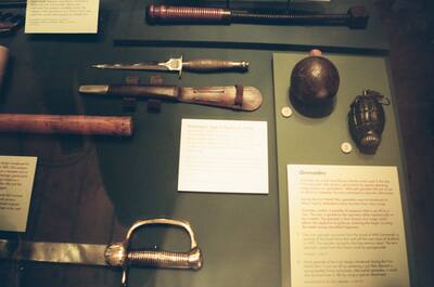 Fairbairn-Sykes knife and grenades in a museum case — Edinburgh, Scotland (August 2000)