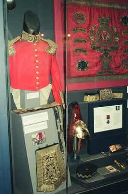 A scarlet officer's tunic and helmet in a regimental display — Edinburgh, Scotland (August 2000)
