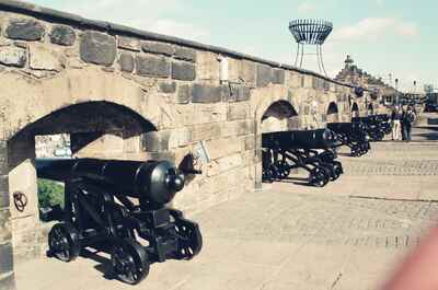 Black cannons set into the castle's arched ramparts — Edinburgh, Scotland (August 2000)