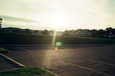 An empty car park glowing in low evening sun — Edinburgh, Scotland (August 2000)