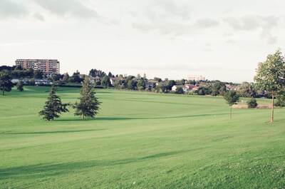 Wide green playing fields with distant flats at Ravelston — Edinburgh, Scotland (August 2000)