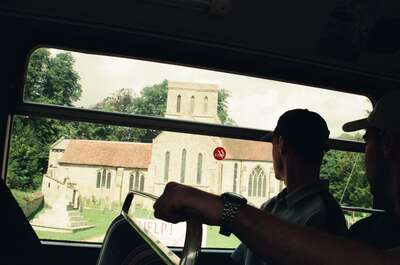 A stone village church glimpsed from the tour bus — Wiltshire, England (mid-August 2000)