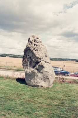 The leaning Heel Stone standing alone beside the road — Stonehenge, England (mid-August 2000)