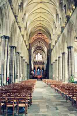 The vaulted nave and stacked chairs inside Salisbury Cathedral — Salisbury, England (mid-August 2000)