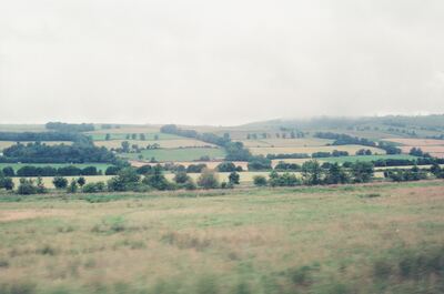 Rolling patchwork farmland under a soft grey sky — Scottish Highlands, Scotland (late July 2000)