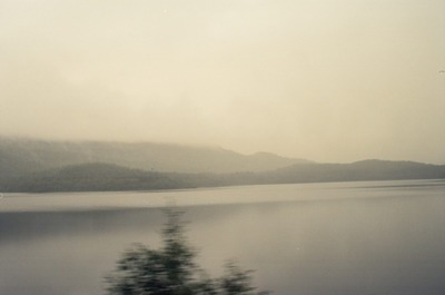 Hazy hills mirrored in a still misty loch — Scottish Highlands, Scotland (late July 2000)