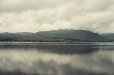 A cloud-draped ridge above a mirror-calm sea loch — Scottish Highlands, Scotland (late July 2000)