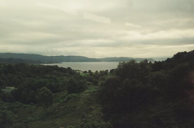 A wooded valley opening onto a distant sea loch — Scottish Highlands, Scotland (late July 2000)