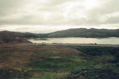 A caravan parked beside a quiet coastal inlet — Scottish Highlands, Scotland (late July 2000)