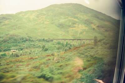 The Glenfinnan Viaduct stretching across a green slope — Glenfinnan, Scotland (August 2000)