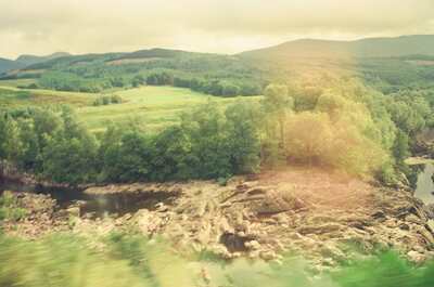 A rocky river gorge below forested Highland hills — Scottish Highlands, Scotland (August 2000)