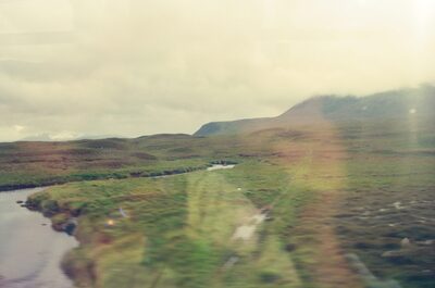 A winding river crossing open Highland moorland — Scottish Highlands, Scotland (August 2000)