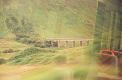 A slender iron viaduct crossing a green glen — Scottish Highlands, Scotland (August 2000)