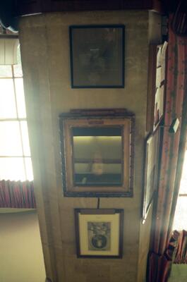 Framed prints and a gilt mirror in a college room — Oxford, England (August 2000)
