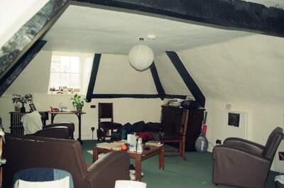 A cluttered attic student room with beamed ceiling — Oxford, England (August 2000)