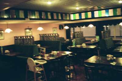 A dim restaurant interior with green booths — Aberystwyth, Wales (August 2000)