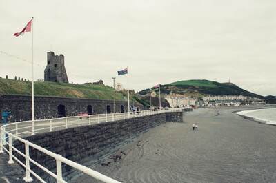 Aberystwyth castle ruins above the seafront promenade — Rome, Wales (August 2000)
