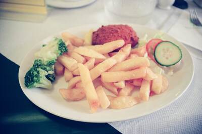 A plate of chips, broccoli and salad at a restaurant — London, England (August 2000)