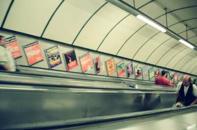 Theatre posters lining a London Underground escalator — London, England (August 2000)