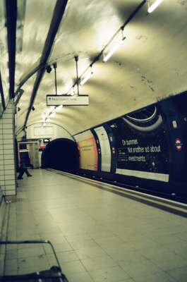 A curving Northern Line tunnel and stairway — London, England (August 2000)