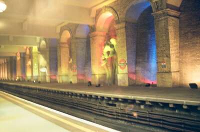 A colourfully lit brick-arched Underground platform — London, England (August 2000)