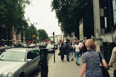 Pedestrians walking down tree-lined Exhibition Road — London, England (August 2000)